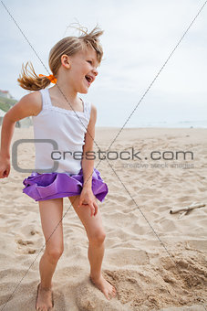 Young girl playing on beach