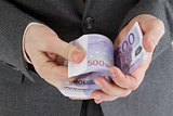 stack banknotes euro in his hand