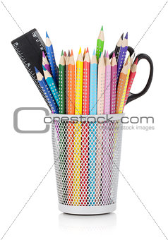 Various colour pencils with ruler and scissors