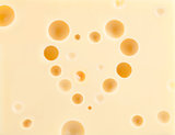 Cheese background with heart shape holes