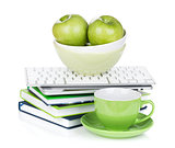 Ripe green apples, coffee cup and office supplies