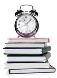 Alarm clock on notepads and books