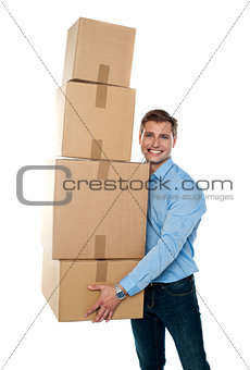 Smiling male holding stack of cartons