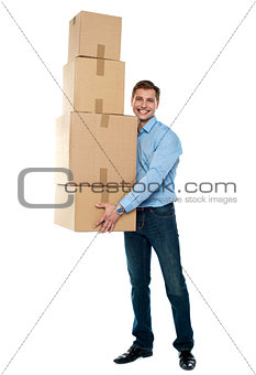 Young man with stack of cartons