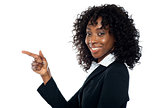 Corporate woman indicating towards copy space