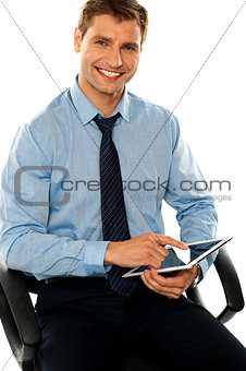 Relaxed businessman using tablet pc