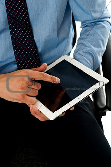 Closeup shot of man operating tablet pc
