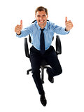 Male executive showing double thumbs up