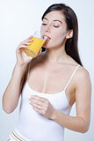 young caucasian woman drinking orange juice
