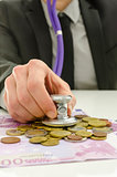 Financial adviser checking money with stethoscope