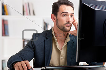 Suprised Man Looking At A Computer Monitor