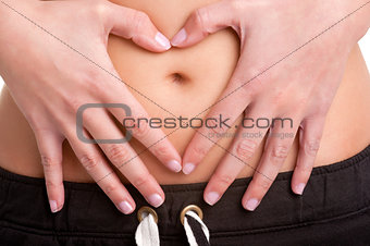 Woman Making a Heart Symbol over her Tummy
