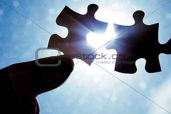 Hand holding jigsaw pieces