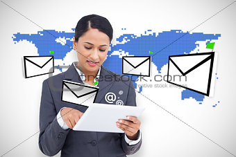 Businesswoman using tablet on digital background