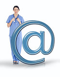 Nurse in scrubs standing beside email at symbol