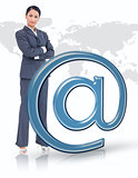 Businesswoman standing by blue email at symbol