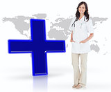 Nurse standing by digital blue cross