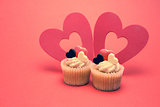 Two valentines cupcakes with heart decorations