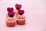 Four valentines muffins with heart decorations