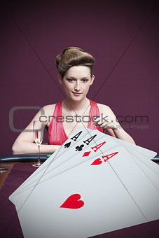 Attractive gambler betting on four aces