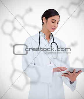 Doctor using tablet pc on chemical formula background