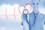 Happy nurse holding up stethoscope to heart design in blue tint