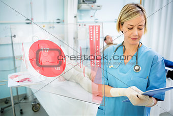 Nurse consulting tablet with screen displaying ECG in foreground