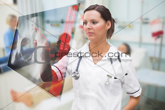 Nurse pressing on screen showing pelvic xray