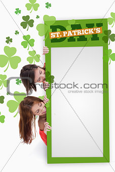 Girls holding blank green placard with patricks day text