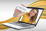 Woman reaching out from laptop showing business card