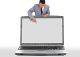 Businessman pointing down to blank laptop screen