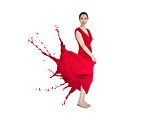 Asian woman smiling with red dress turning to paint splatter
