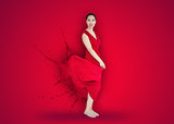 Asian woman with red dress turning to paint splatter