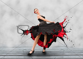 Flamenco dancer with dress turning to paint splashes