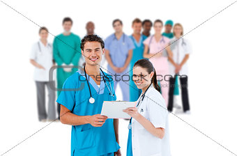 Nurse and doctor holding clipboard and smiling