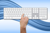 Hand pressing key on blank keyboard