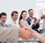 Businessman and woman shaking hands in presentation