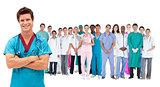 Smiling surgeon in front of a team of doctors standing together