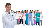 Smiling doctor in front of a team of doctors standing together