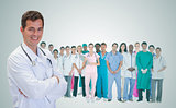 Smiling doctor in front of a team of doctors standing together