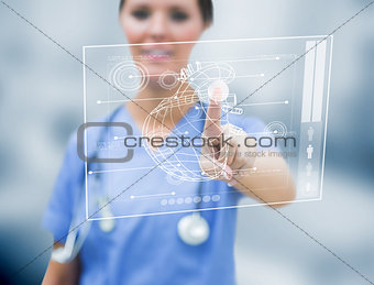 Female cardiologist touching a medical interface