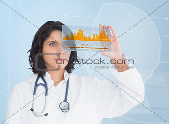 Brunette doctor looking at a graph with new technology