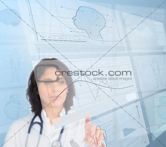 Woman doctor using futuristic interfaces