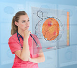 Thoughtful nurse using a futuristic interface