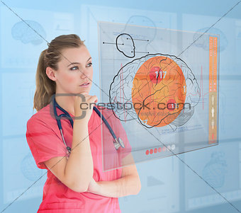 Thoughtful nurse using a futuristic interface