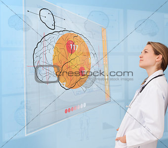 Thoughtful doctor using an interface for brain analysis