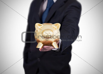 Businessman showing a piggy bank