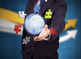 Businessman with colored puzzles and a globe