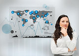 Businesswoman standing with a digital world map