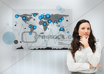 Businesswoman standing with a digital world map